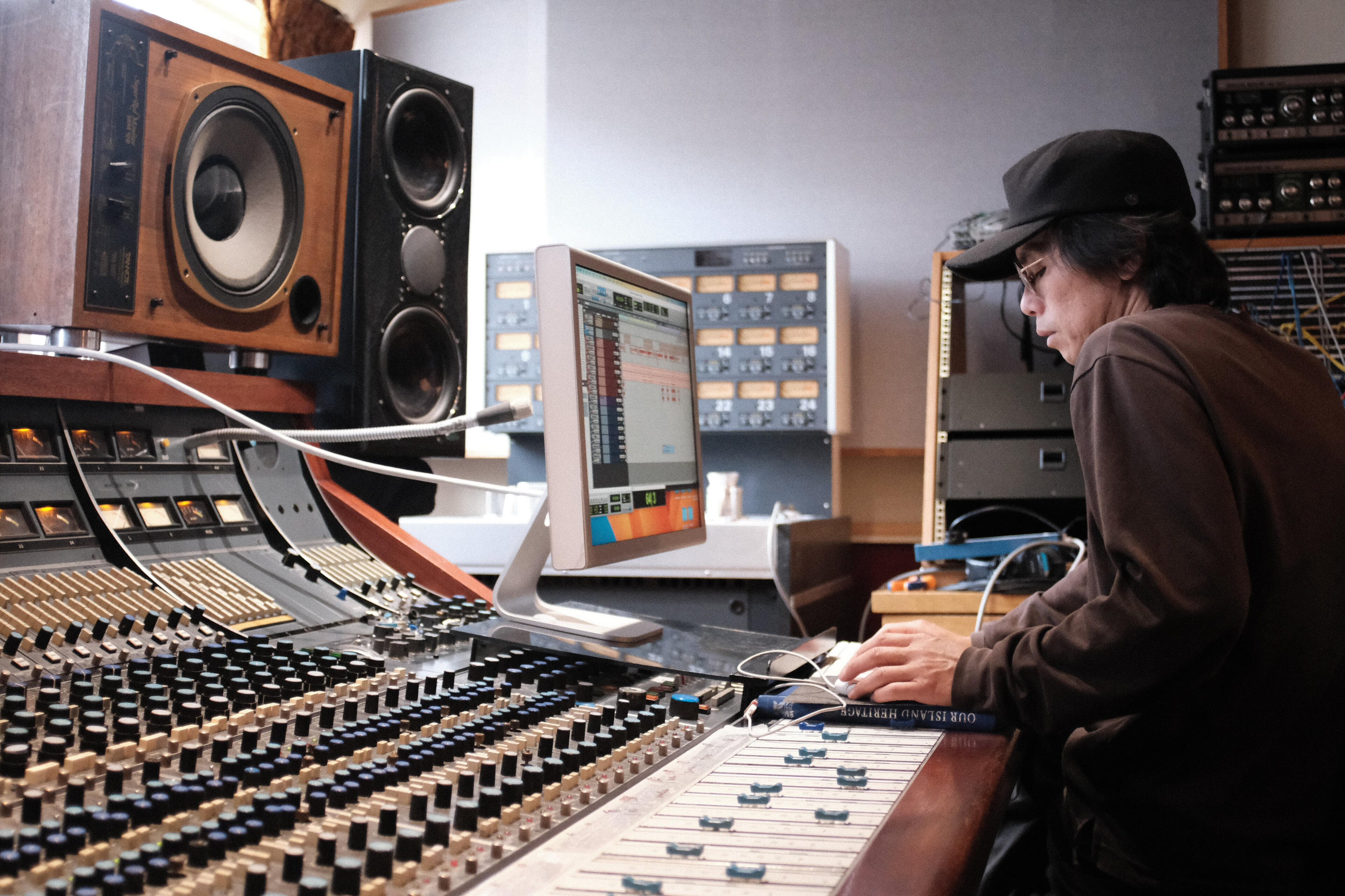 Shuta Shinoda working at an analog mixing console in the studio